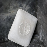 portrait image, white tailors chalk, angled lean on black rustic background.