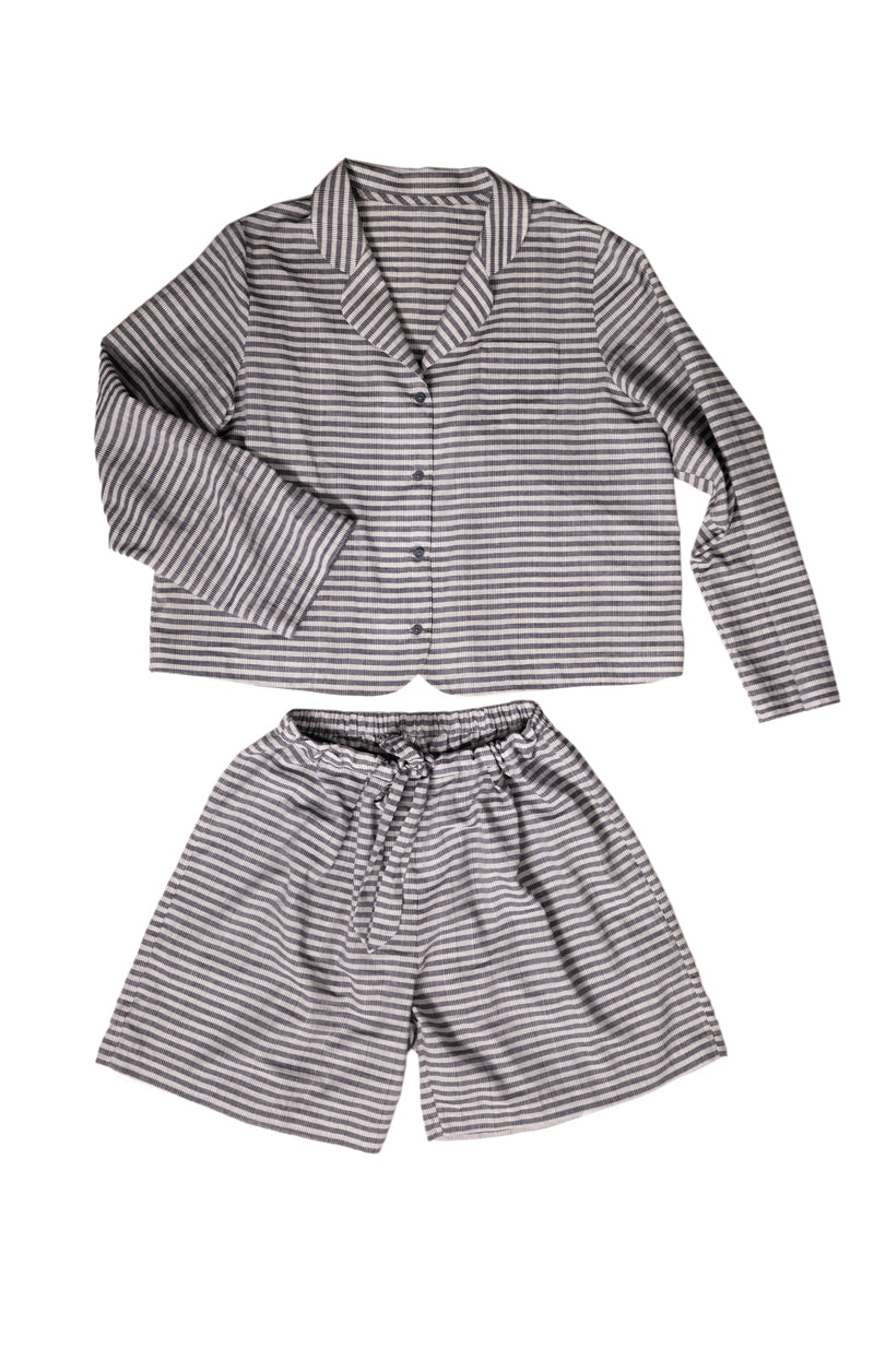 portrait image, merchant and mills Winnie pyjama pattern, flat lay pyjamas, longsleeve shirt, elasticated waist shorts, white background, fabric is brown and light mauve stripe.
