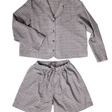 portrait image, merchant and mills Winnie pyjama pattern, flat lay pyjamas, longsleeve shirt, elasticated waist shorts, white background, fabric is brown and light mauve stripe.