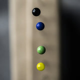 portrait image,, blurred background, birds eye view, top of pins, white head, black head, blue head, green head, yellow head, red head.