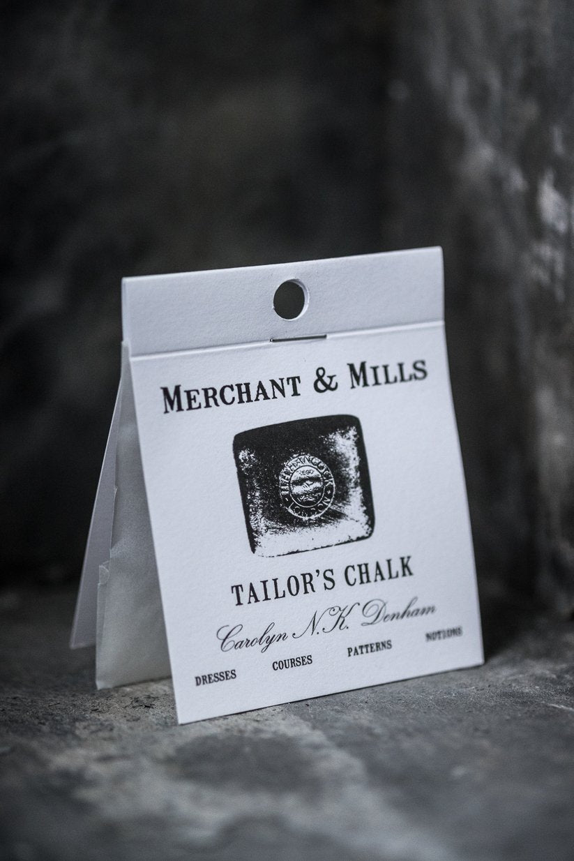 portrait photo, standing card covered packet, white, black text, merchant and mills, tailors chalk