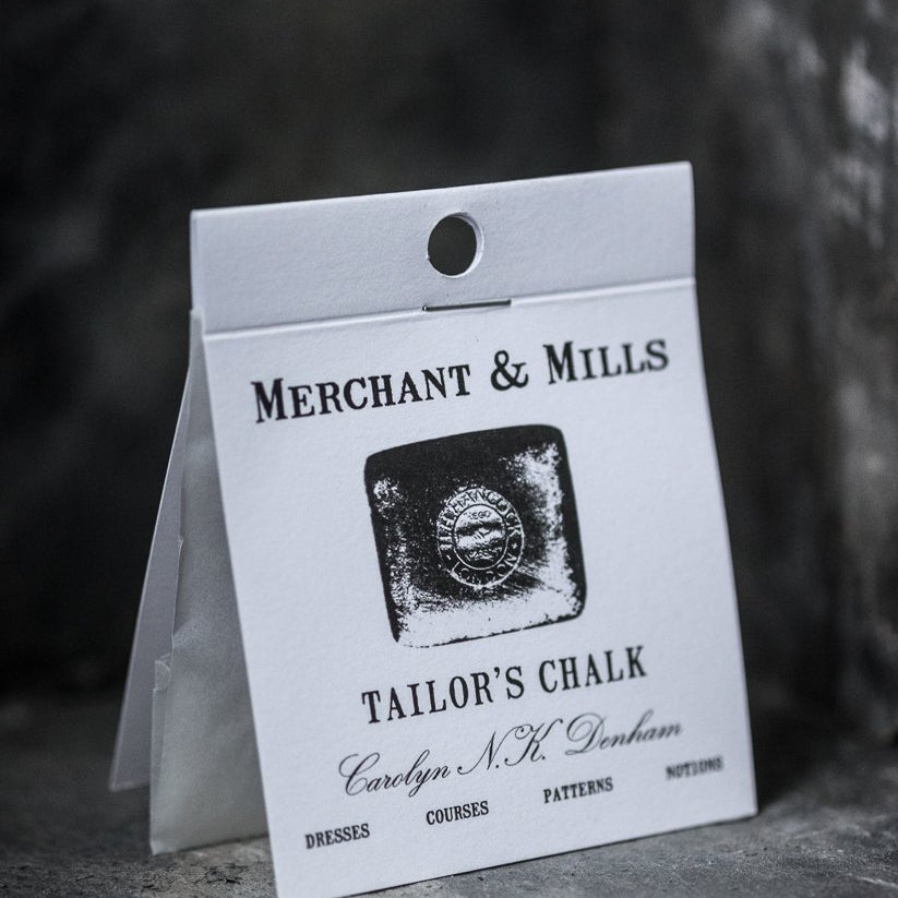 portrait photo, standing card covered packet, white, black text, merchant and mills, tailors chalk